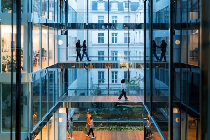 People walking through an office building
